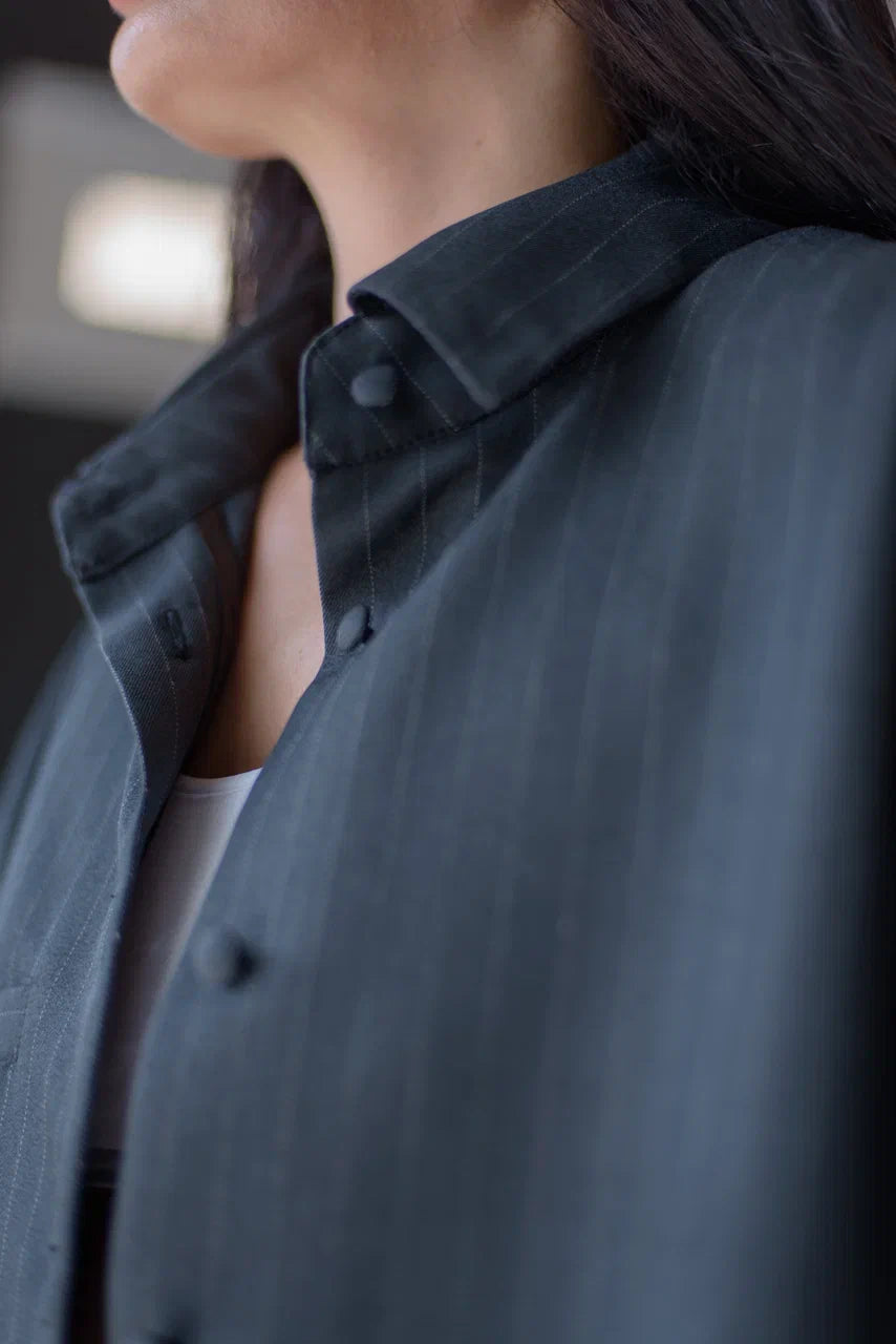Close-up of the collar on the oversized pinstripe overshirt.