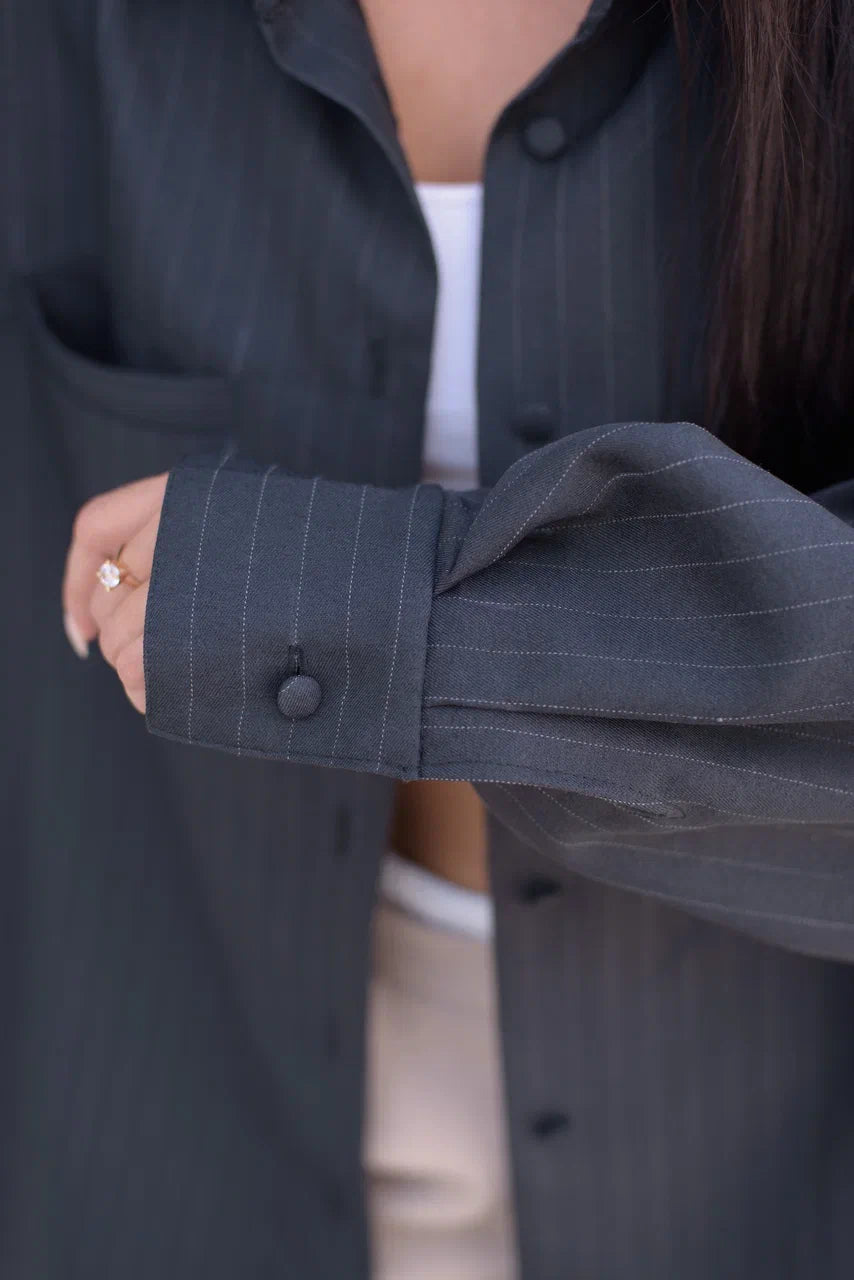 Close-up of the cuff and stiching on the oversized pinstripe blazer shirt.