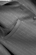 Close-up of a gray pinstripe suit jacket showing the fabric texture, a button, and a pocket.